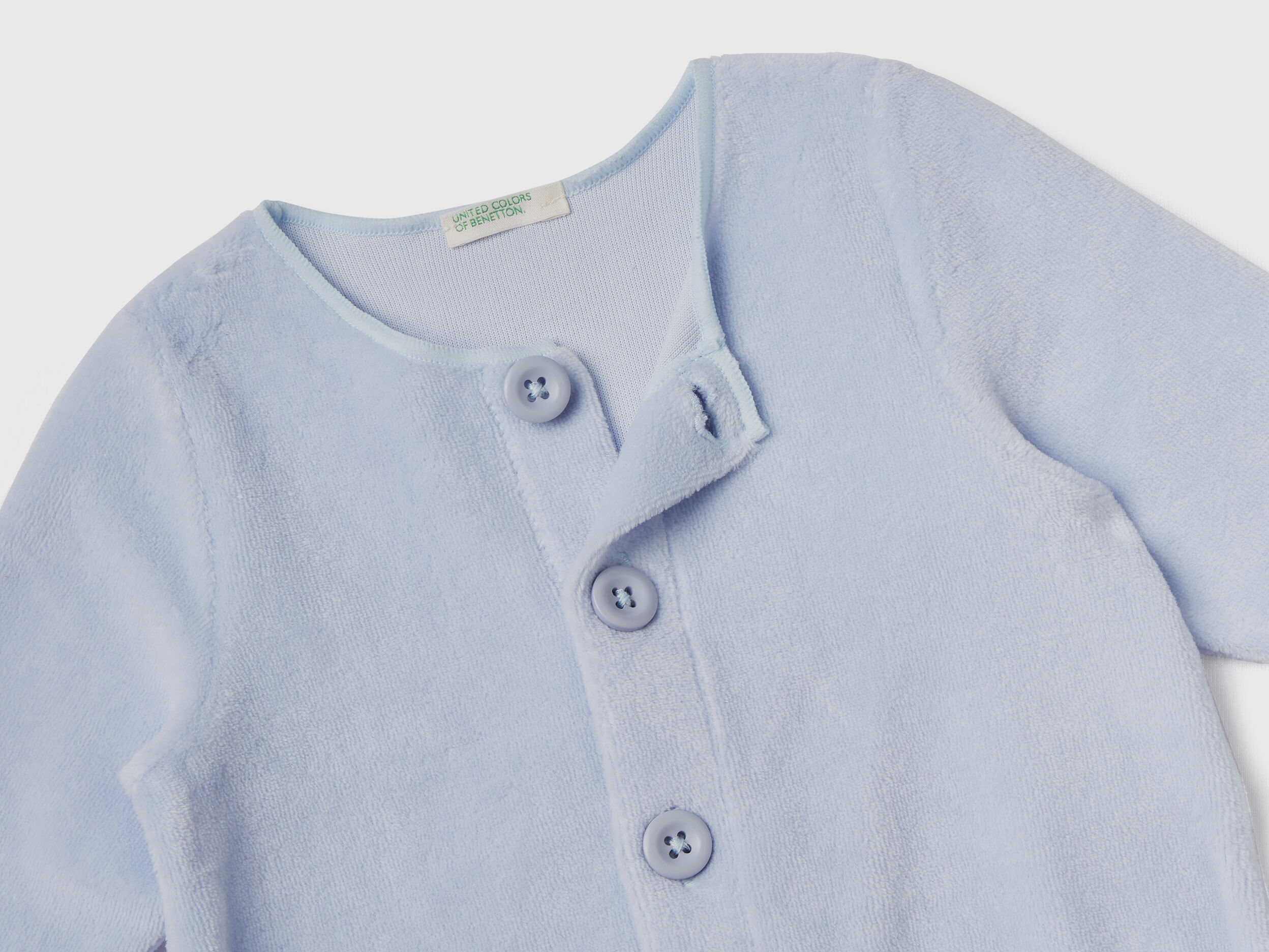 Tutina in ciniglia con taschini Celeste Benetton