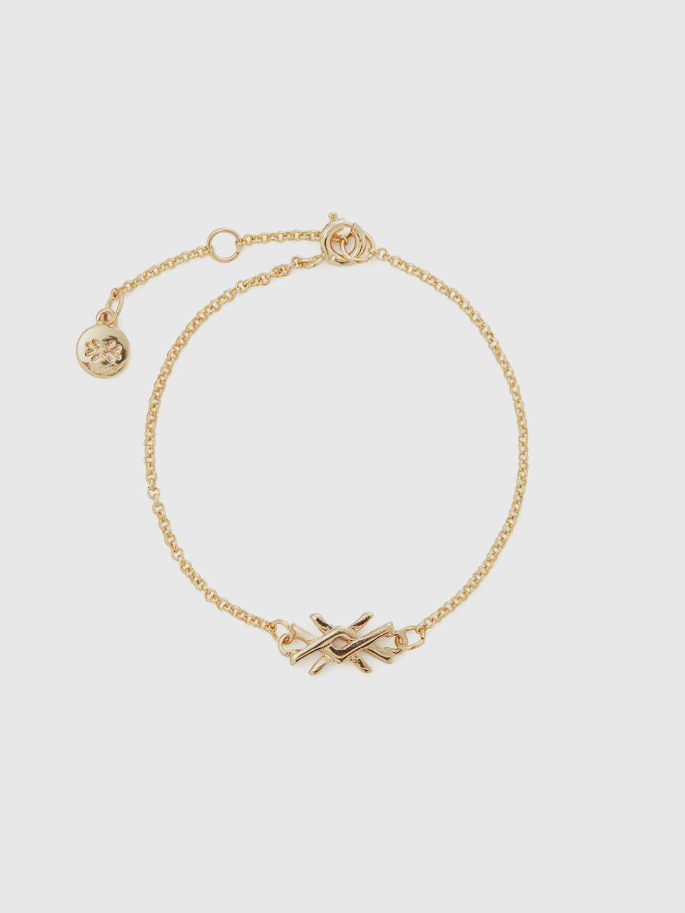 Gold bracelet with charm and logo